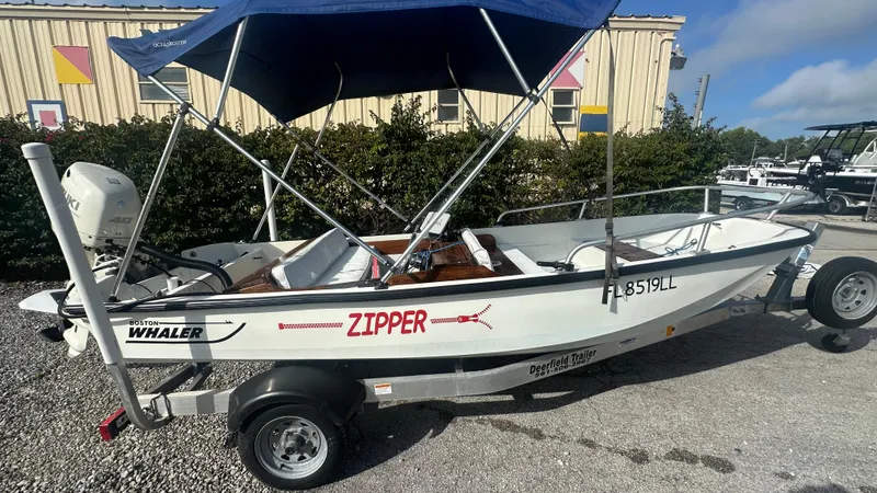 Slide: The Image of 1971 Boston Whaler 13 Sport boat with canopy on trailer, labeled "Zipper." - 2