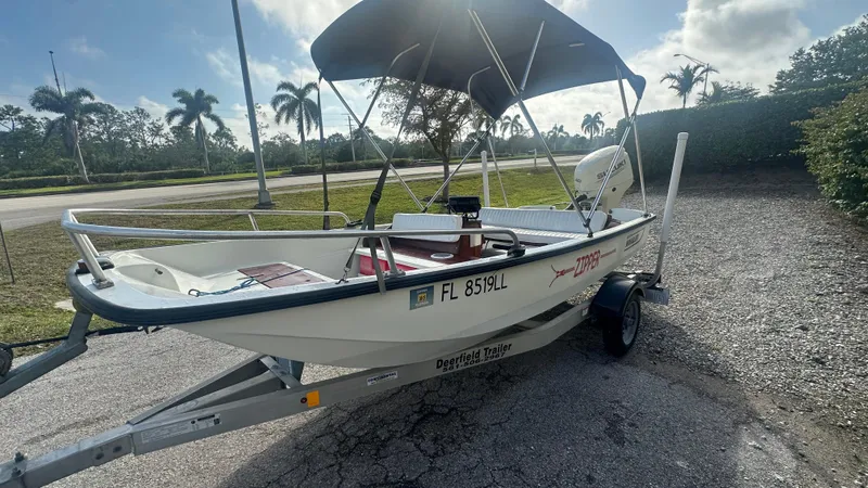 Slide: The Image of 1971 Boston Whaler 13 Sport boat with canopy on trailer, parked outdoors. - 7