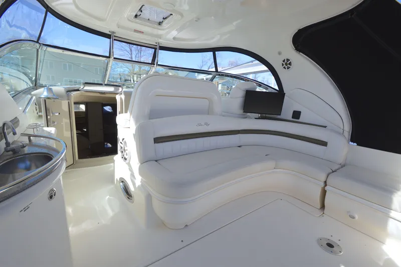 Slide: The Image of 2007 Sea Ray 44 Sundancer interior with white seating and modern amenities. - 12
