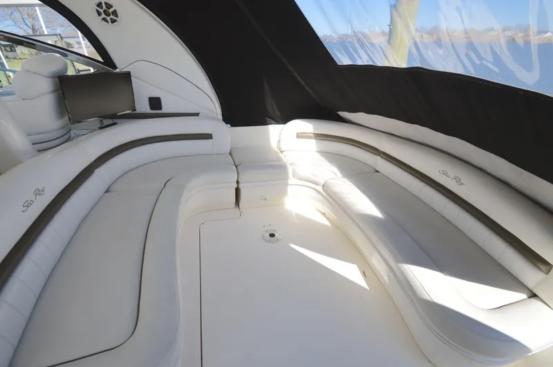 Slide: The Image of Luxurious interior of 2007 Sea Ray 44 Sundancer yacht with white seating and a small TV. - 14