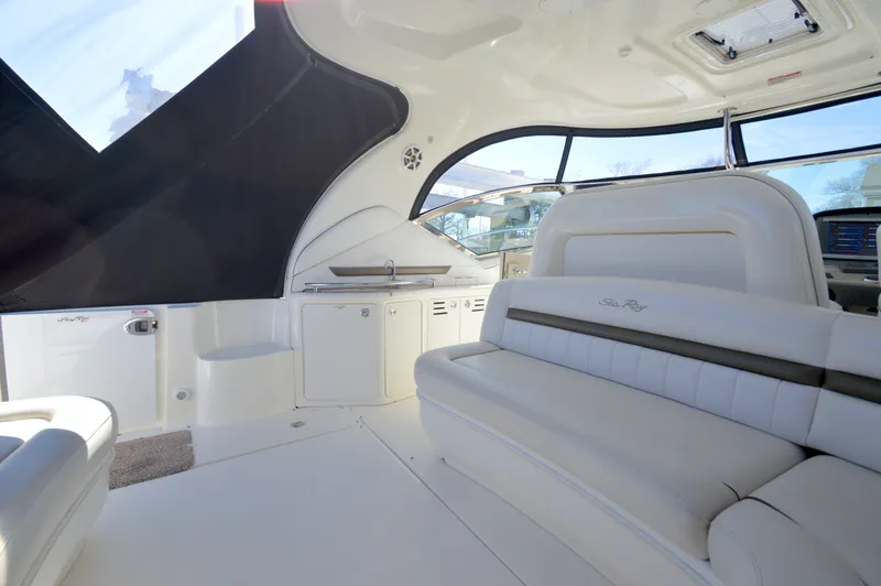 Slide: The Image of 2007 Sea Ray 44 Sundancer interior with white seating and sleek design. - 15