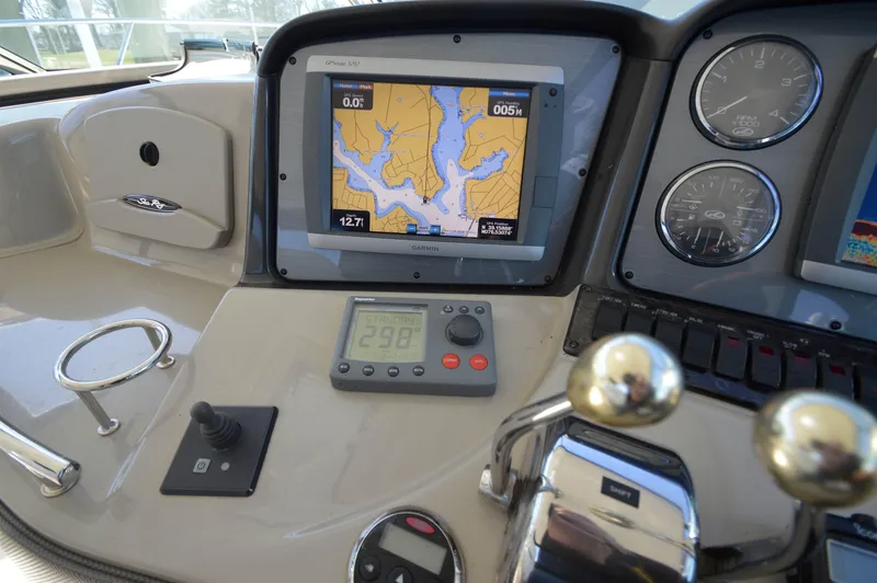 Slide: The Image of Control panel of a 2007 Sea Ray 44 Sundancer with navigation display and gauges. - 24