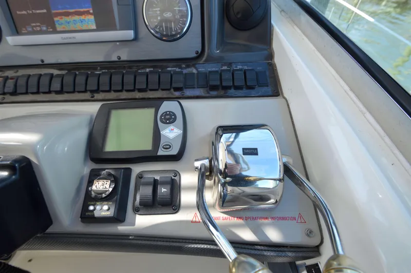 Slide: The Image of Control panel of a 2007 Sea Ray 44 Sundancer boat with throttle and navigation instruments. - 25
