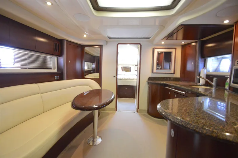 Slide: The Image of Luxurious interior of 2007 Sea Ray 44 Sundancer yacht with elegant seating and modern kitchen. - 31