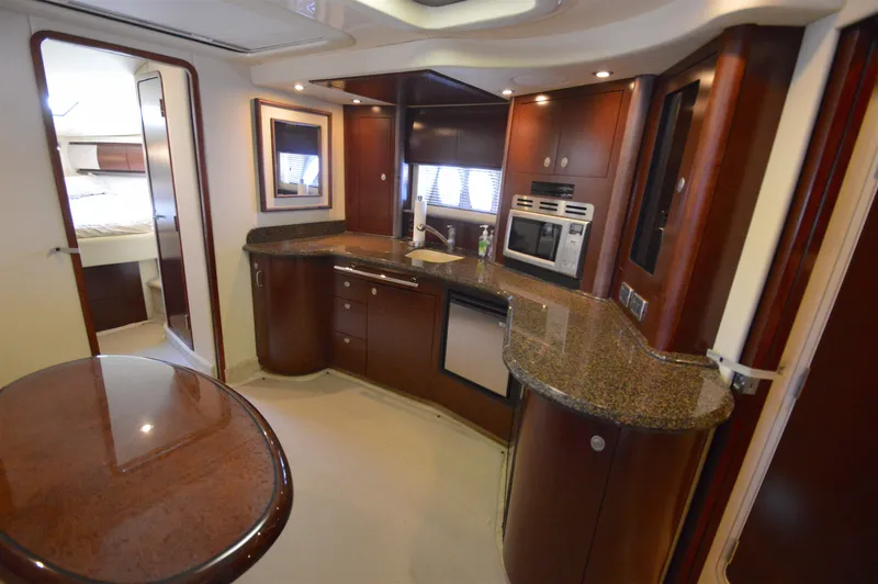 Slide: The Image of Luxurious 2007 Sea Ray 44 Sundancer yacht interior with modern kitchen and elegant wood finishes. - 33