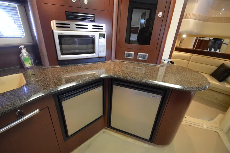 Slide: The Image of Luxurious 2007 Sea Ray 44 Sundancer yacht kitchen with granite countertops and modern appliances. - 35