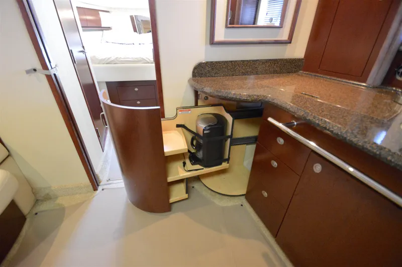 Slide: The Image of 2007 Sea Ray 44 Sundancer interior with open cabinet and coffee maker. - 37