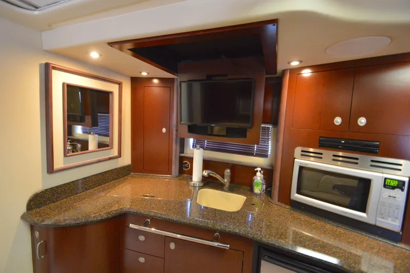 Slide: The Image of Luxurious 2007 Sea Ray 44 Sundancer yacht kitchen with modern appliances and sleek design. - 38