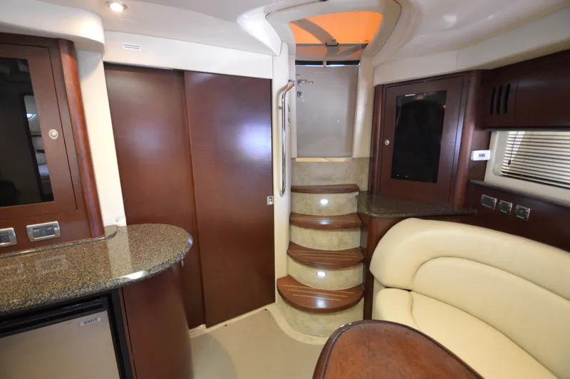 Slide: The Image of Interior of 2007 Sea Ray 44 Sundancer yacht with elegant wood finishes and curved seating. - 49