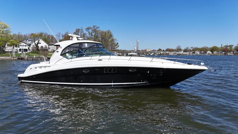 Slide: The Image of 2007 Sea Ray 44 Sundancer yacht on calm water, clear sky background. - 7