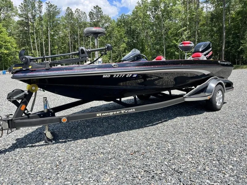 Slide: The Image of 2014 Ranger Z118 Comanche boat on trailer in outdoor setting. - 0