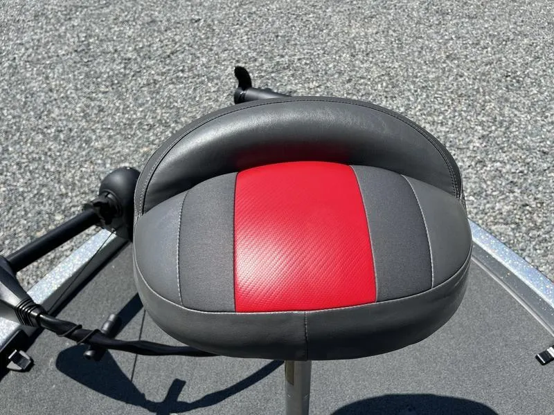 Slide: The Image of 2014 Ranger Z118 Comanche boat seat with red and gray upholstery on a textured surface. - 12
