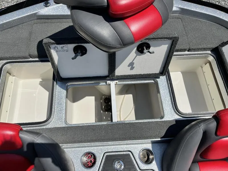 Slide: The Image of 2014 Ranger Z118 Comanche boat interior with storage compartments and red-black seats. - 14