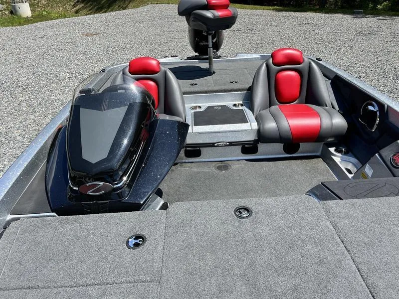 Slide: The Image of 2014 Ranger Z118 Comanche boat interior with red and black seats, gray carpet, and motor. - 15