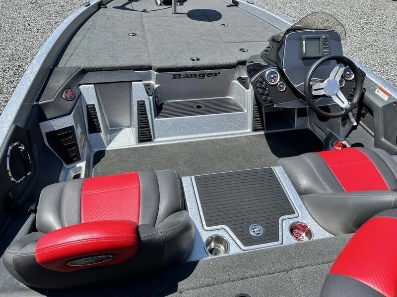 Slide: The Image of 2014 Ranger Z118 Comanche boat interior with red and gray seats, steering wheel, and dashboard. - 16