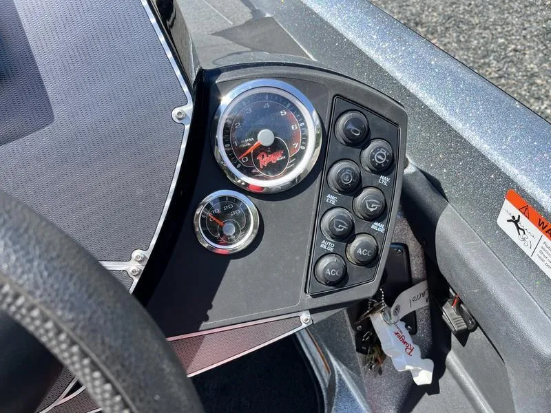 Slide: The Image of Dashboard of a 2014 Ranger Z118 Comanche boat with gauges and control buttons. - 19
