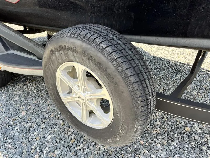 Slide: The Image of 2014 Ranger Z118 Comanche trailer tire on gravel surface. - 7