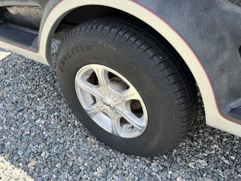 Slide: The Image of 2014 Ranger Z118 Comanche wheel on gravel surface. - 8