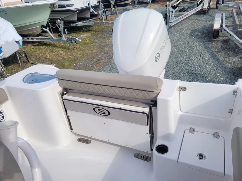 Slide: The Image of 2023 Sportsman Open 232 Center Console boat interior with seating and storage. - 11