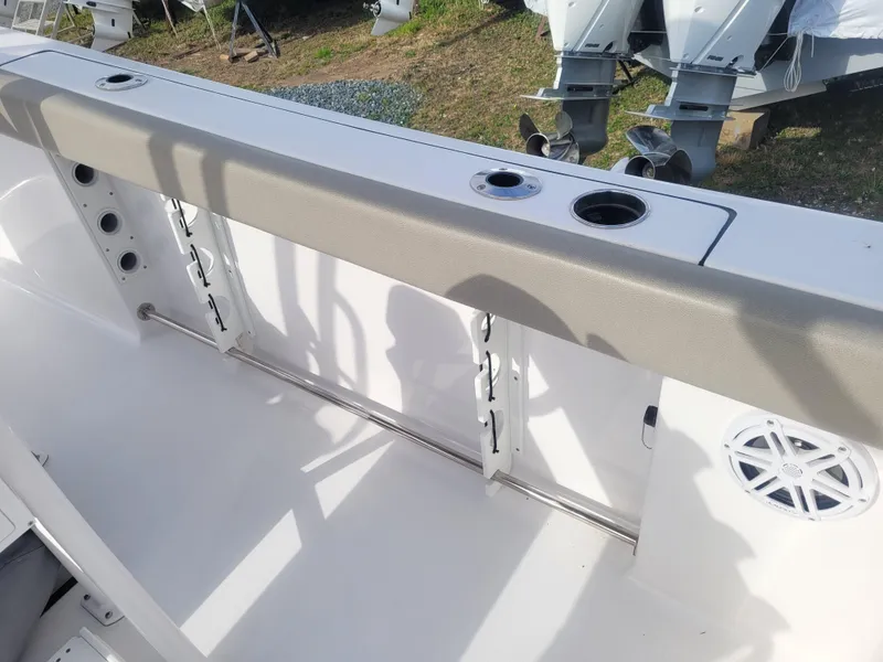 Slide: The Image of 2023 Sportsman Open 232 Center Console boat interior with rod holders and cup holders. - 13