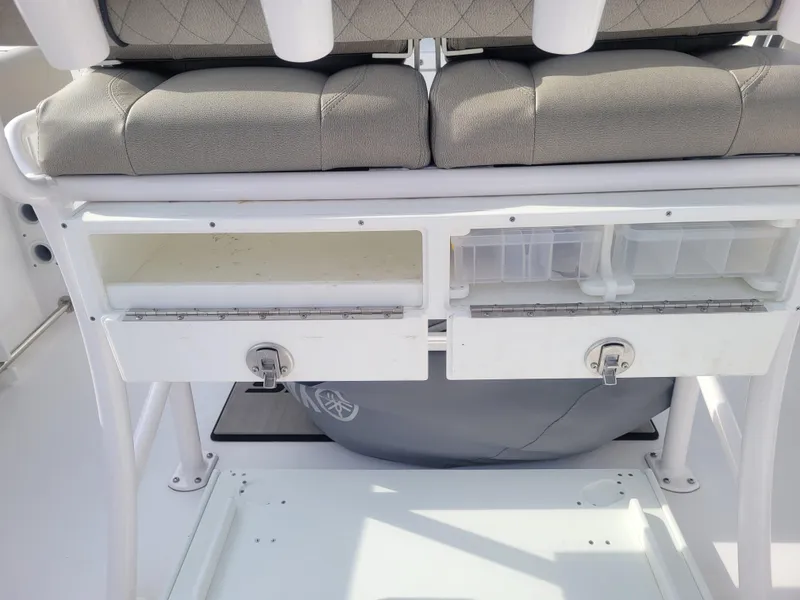 Slide: The Image of 2023 Sportsman Open 232 Center Console boat storage compartments and seating. - 17