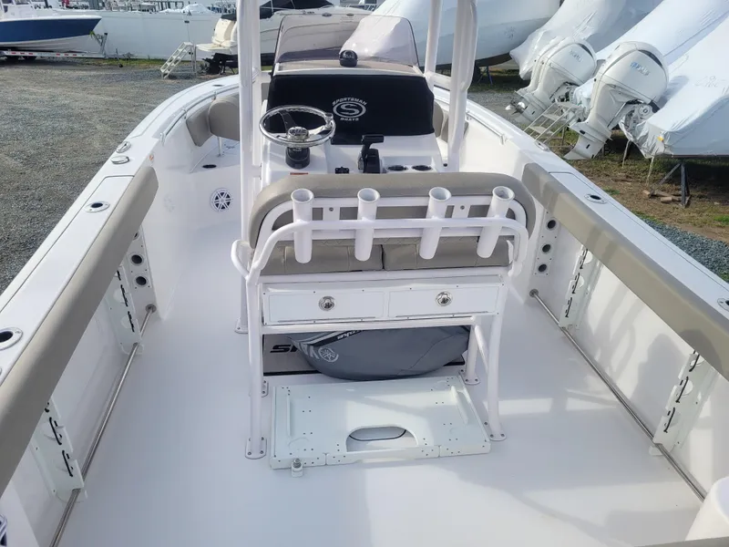 Slide: The Image of 2023 Sportsman Open 232 Center Console boat interior with rod holders and seating. - 18