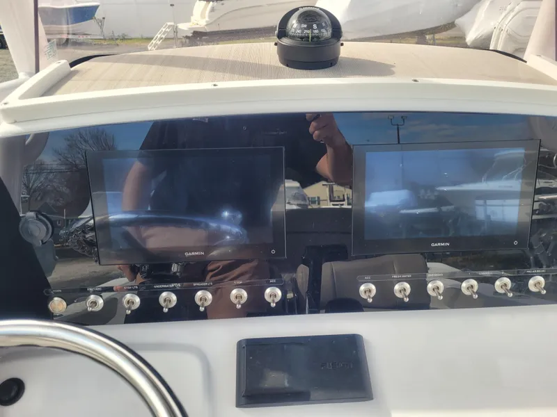 Slide: The Image of 2023 Sportsman Open 232 Center Console dashboard with dual Garmin displays and controls. - 20