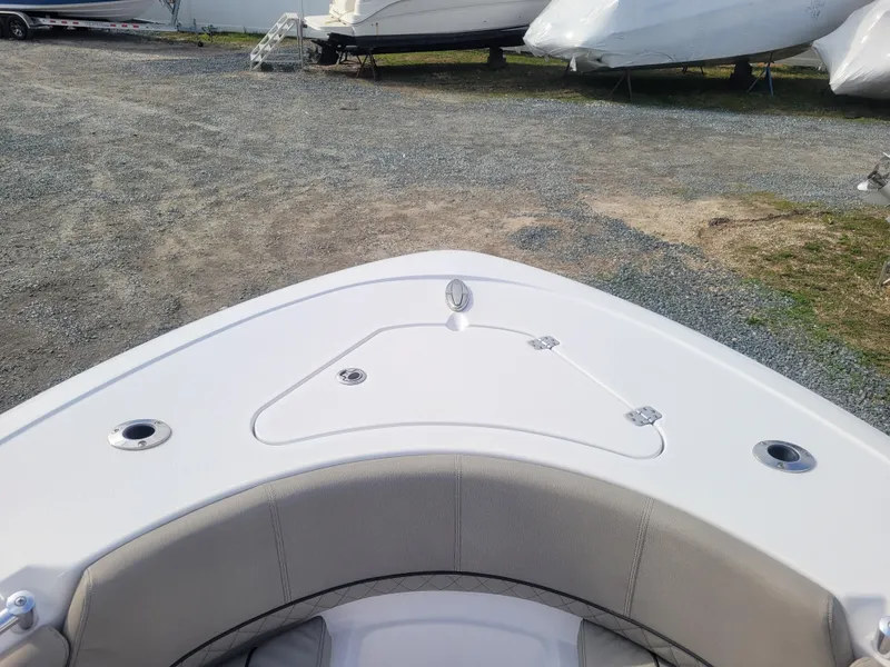 Slide: The Image of 2023 Sportsman Open 232 Center Console boat bow view in a gravel lot. - 25