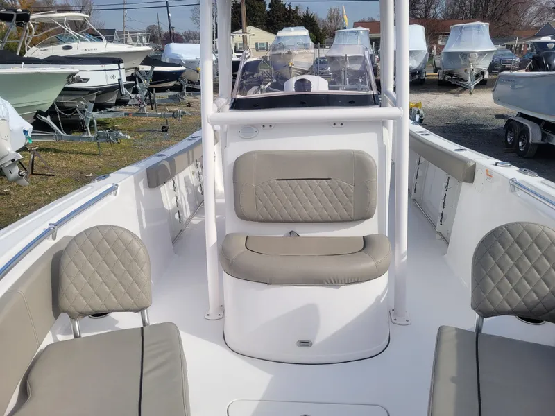 Slide: The Image of 2023 Sportsman Open 232 Center Console boat interior with seating and console view. - 26
