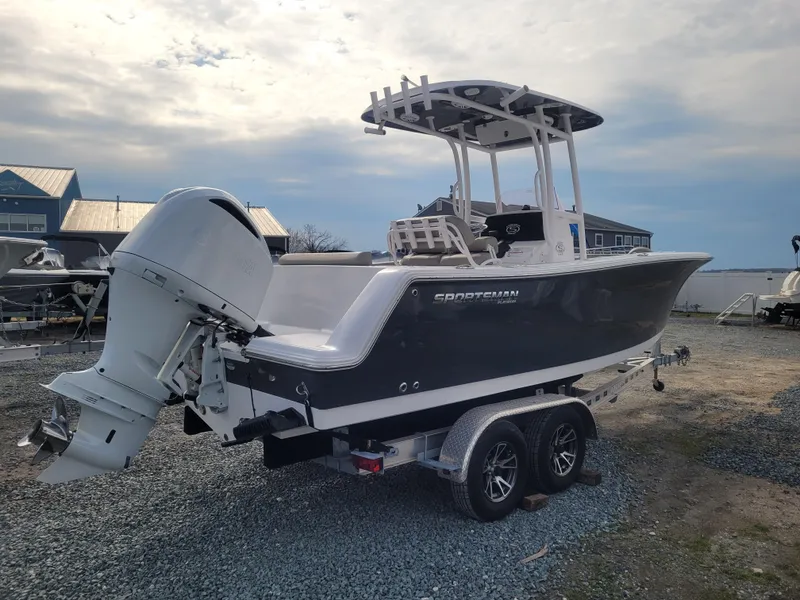 Slide: The Image of 2023 Sportsman Open 232 Center Console boat on trailer, parked outdoors. - 4