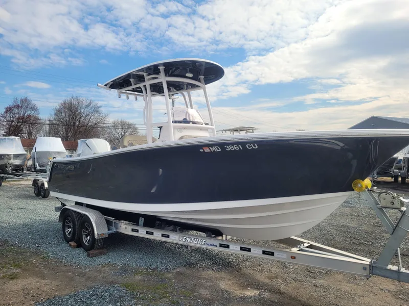 Slide: The Image of 2023 Sportsman Open 232 Center Console boat on trailer under cloudy sky. - 7