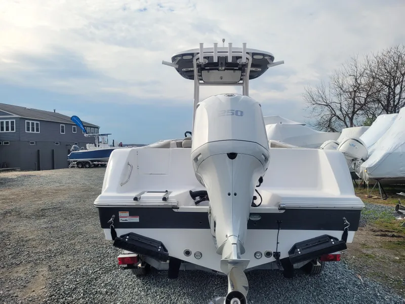 Slide: The Image of 2023 Sportsman Open 232 Center Console boat with powerful outboard motor. - 8