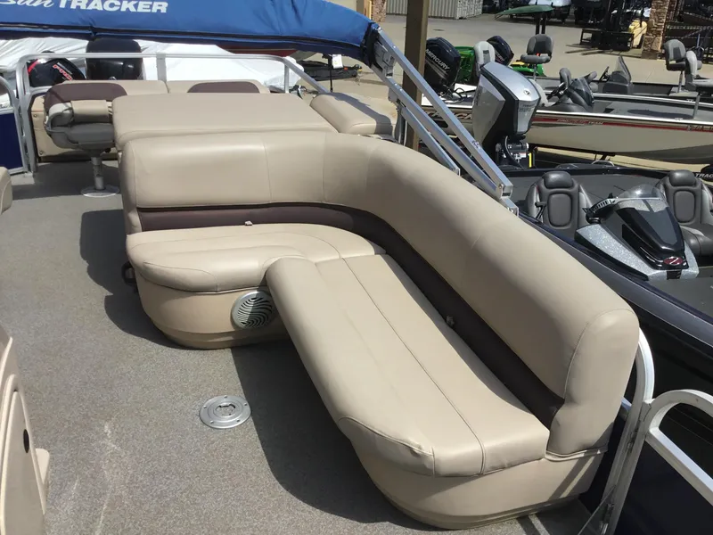 Slide: The Image of 2017 Sun Tracker Fishin' Barge 22 DLX with beige seating and blue canopy. - 13