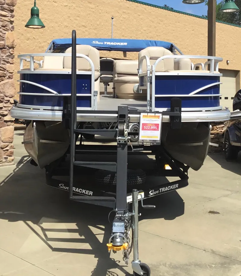 Slide: The Image of 2017 Sun Tracker Fishin' Barge 22 DLX pontoon boat displayed outdoors. - 5