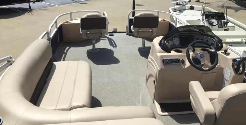 Slide: The Image of 2017 Sun Tracker Fishin' Barge 22 DLX interior with beige seating and steering console. - 7
