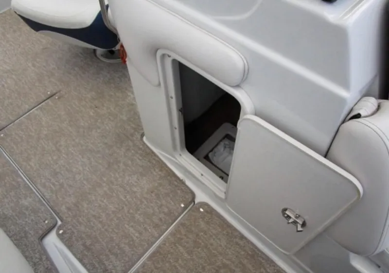 Slide: The Image of 2012 Crownline E1EC1Z boat interior storage compartment with carpeted flooring. - 11