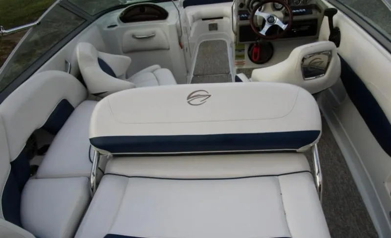 Slide: The Image of 2012 Crownline E1EC1Z boat interior with white and blue seating and steering wheel. - 13