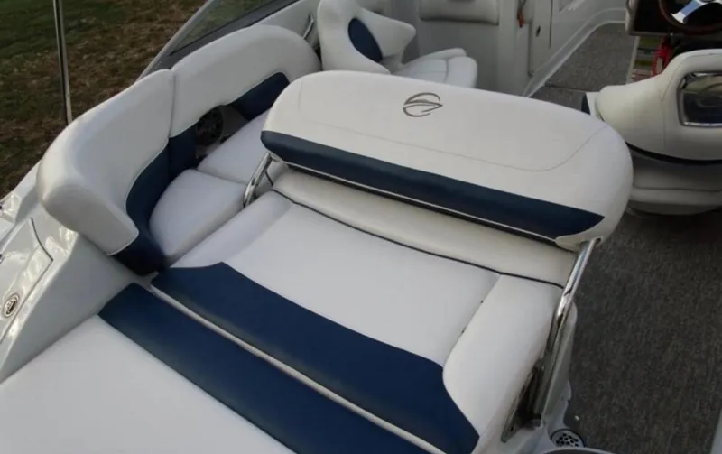 Slide: The Image of 2012 Crownline E1EC1Z boat interior with white and blue cushioned seating. - 9