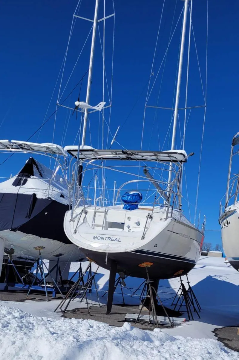Slide: The Image of 2004 Jeanneau SO 37 sailboat on stands in snowy marina. - 11
