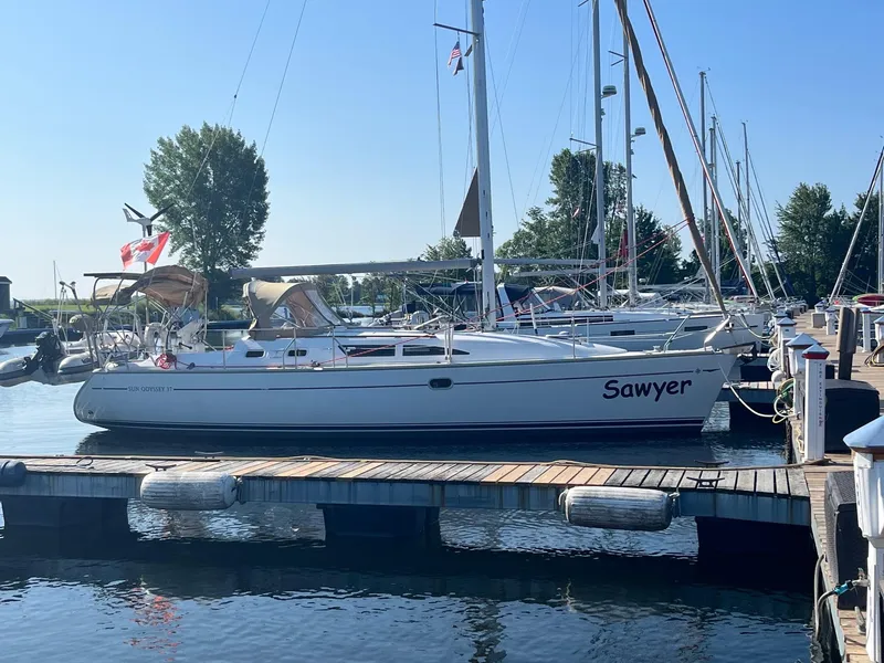 Slide: The Image of 2004 Jeanneau SO 37 sailboat named "Sawyer" docked at a marina. - 2