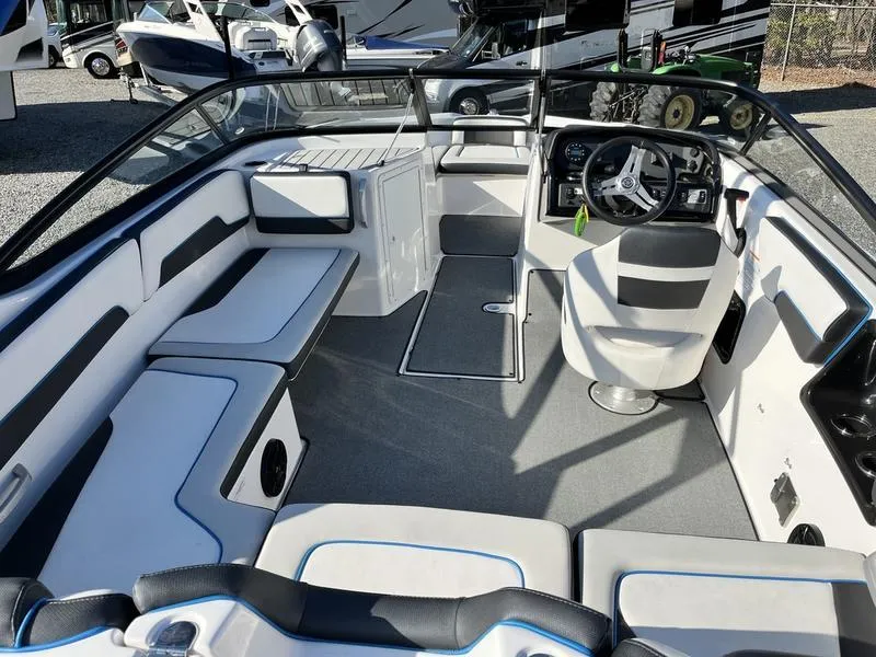 Slide: The Image of 2021 Yamaha Boats AR195 interior with sleek seating and modern dashboard. - 5