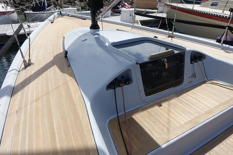 Slide: The Image of 2006 Maxi Dolphin CrossCurrent 33 sailboat deck with sleek design and wooden finish. - 15