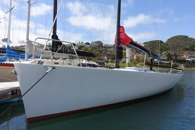 Slide: The Image of 2006 Maxi Dolphin CrossCurrent 33 sailboat docked in a marina, clear sky background. - 4