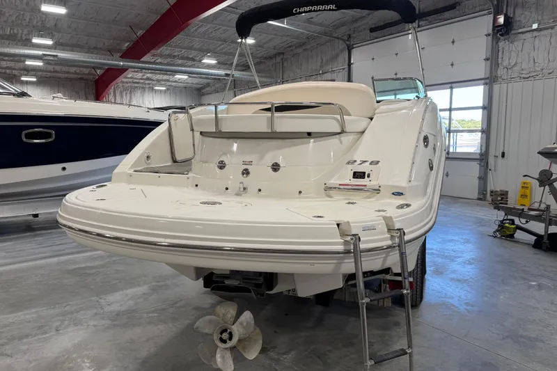Slide: The Image of 2007 Chaparral 276 SSi boat in a garage, rear view with swim platform and ladder. - 20