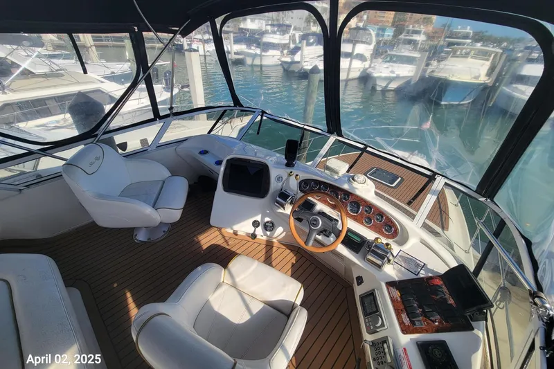 Slide: The Image of Cockpit of 2000 Sea Ray 380 Aft Cabin yacht with marina view, dated April 02, 2025. - 16