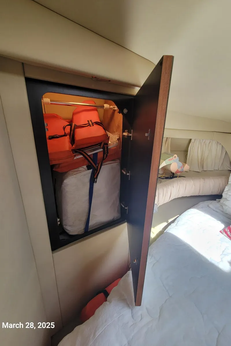 Slide: The Image of Storage compartment on a 2000 Sea Ray 380 Aft Cabin with life jackets and gear. - 37