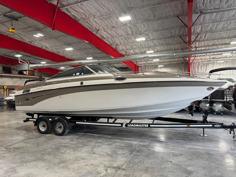Slide: The Image of 2003 Crownline 280 BR boat on Loadmaster trailer in indoor storage facility. - 1