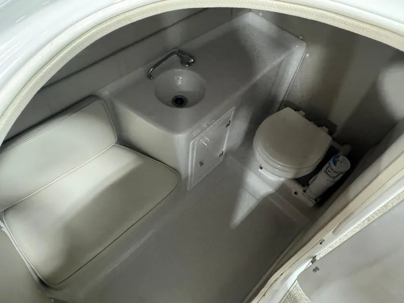 Slide: The Image of 2003 Crownline 280 BR boat interior with sink and toilet. - 11