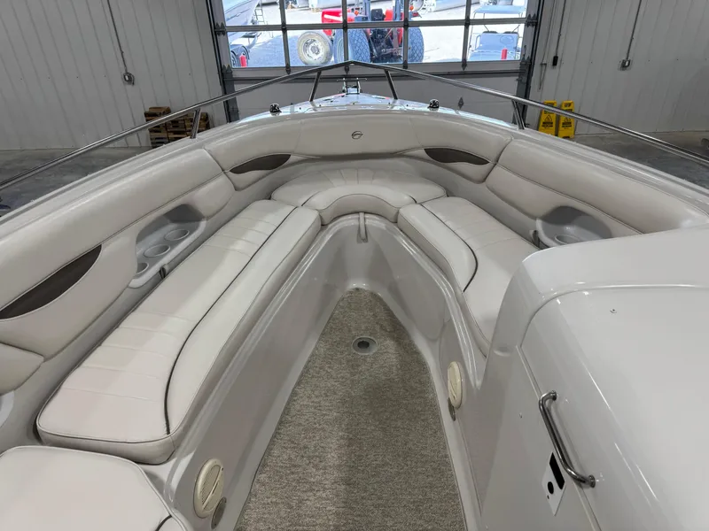 Slide: The Image of 2003 Crownline 280 BR boat interior with white seating and carpeted floor. - 12