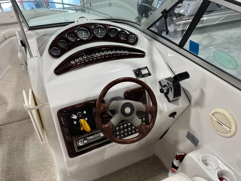 Slide: The Image of 2003 Crownline 280 BR boat dashboard with steering wheel and control panel. - 13